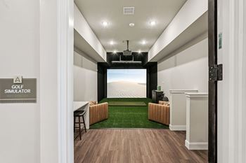 A room with a golf simulator sign on the wall